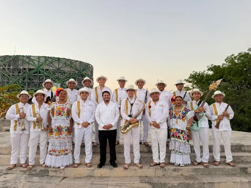 La orquesta y bailadores de jarana posando frente al Gran Museo del Mundo Maya